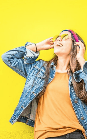 A young woman against a bright yellow background