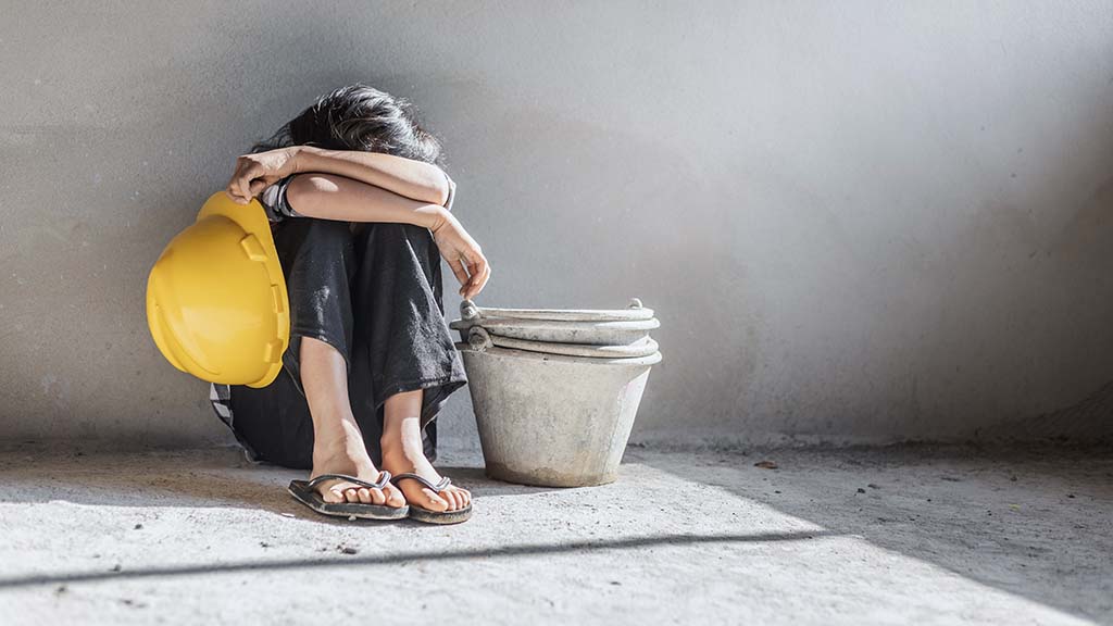 A young girl in forced child labor
