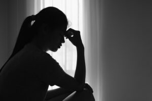 The silhouette of a woman who is distressed
